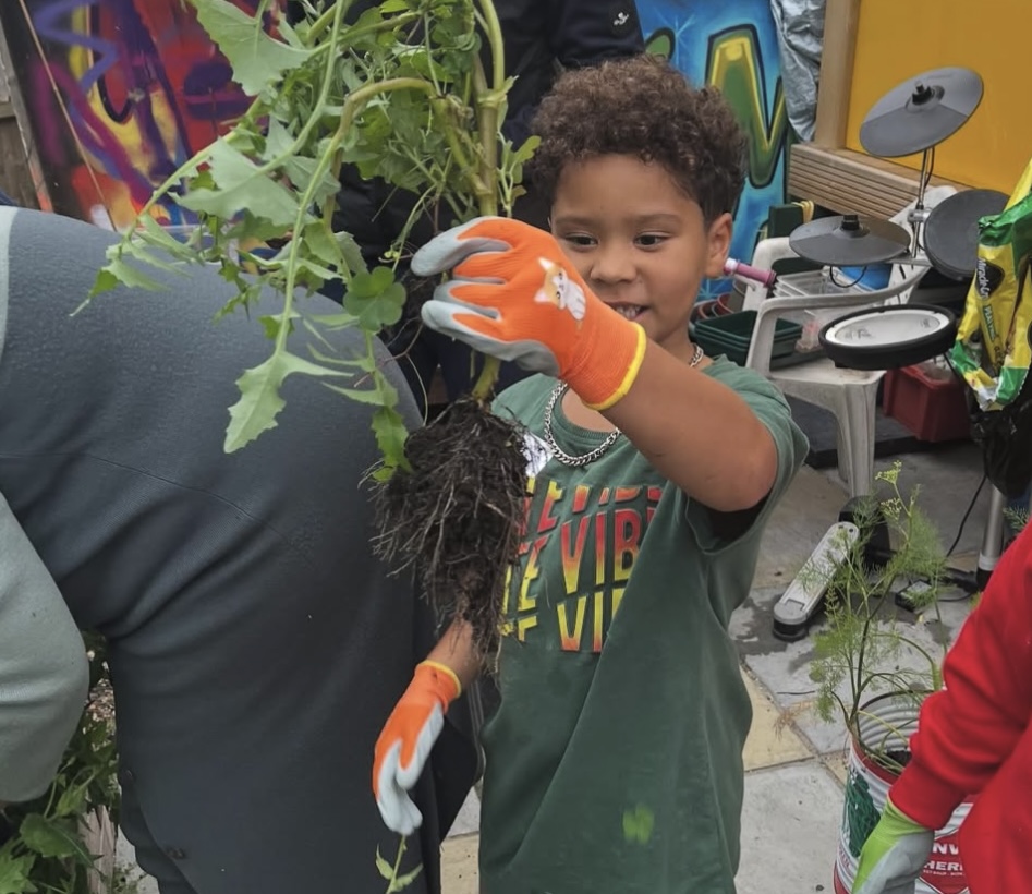 Children discovering plants in the garden with magnifying glasses